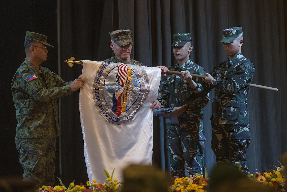Armed Forces of the Philippines Lt. Gen. Oscar T. Lactao, left, and U.S. Marine Lt. Gen. Lawrence D. Nicholson unfurl the Balikatan 2017 flag during the opening ceremony at Camp Aguinaldo, Quezon City, May 8, 2017. Lactao is the Philippine exercise director for Balikatan and Nicholson is the commanding general of III Marine Expeditionary Force. Balikatan is an annual U.S.-Philippine bilateral military exercise focused on a variety of missions including humanitarian and disaster relief, counterterrorism, and other combined military operations. 