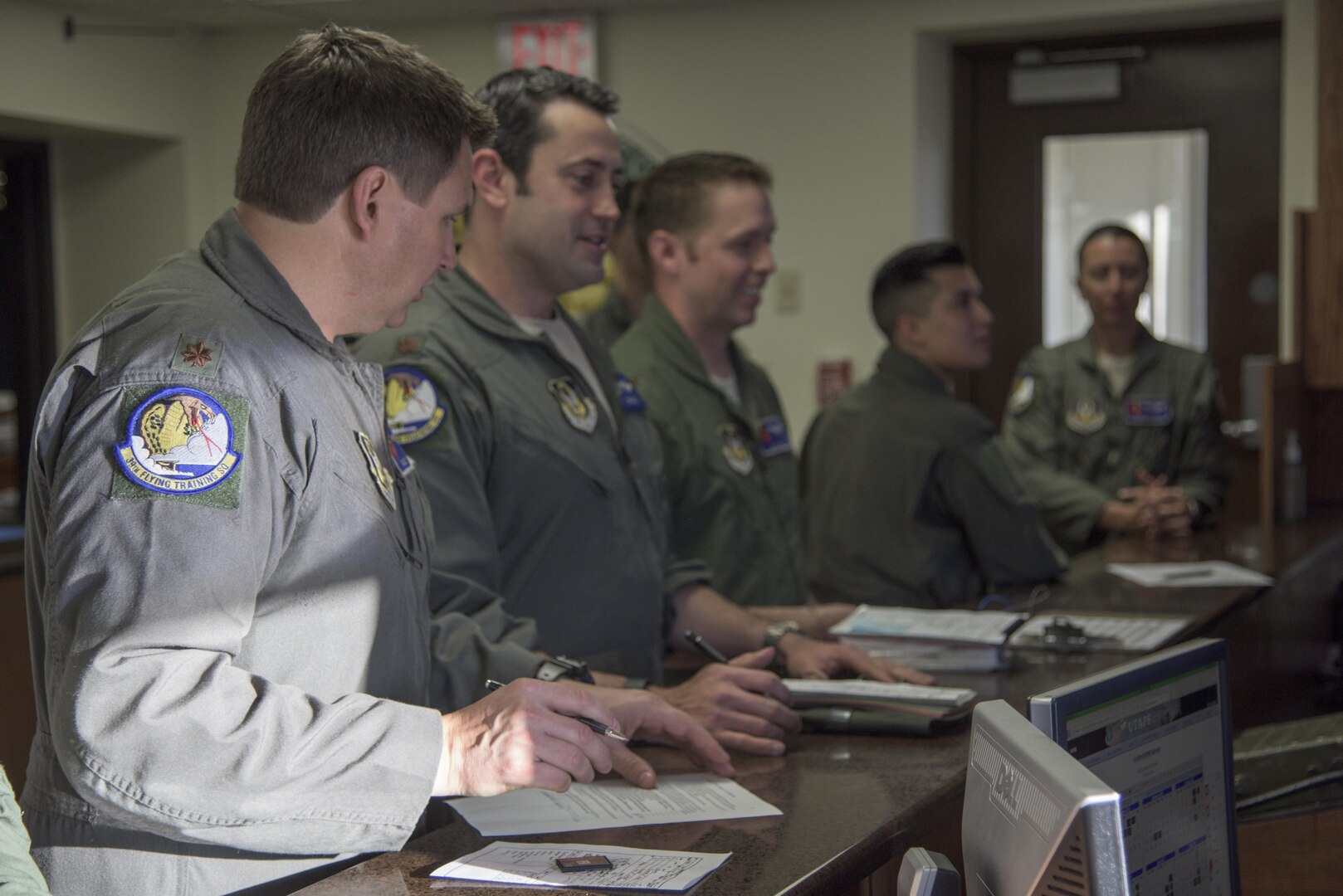 Members of the 39th Flying Training Squadron receive a pre-flight briefing May 4, 2017, at Joint Base San Antonio-Randolph, Texas during the Cobras in the Clouds exercise. The exercise gave 39th FTS members a chance to practice their war-time mission of taking control of the training mission of the 12th Operations Group. (U.S. Air Force photo by Senior Airman Stormy Archer)