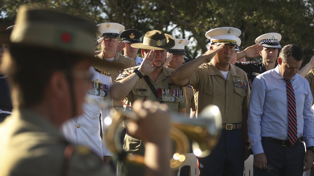 U.S. Marines with Marine Rotational Force Darwin and Australian Defence Force service members render a salute during the playing of Last Post at memorial for the Battle of the Coral Sea, May 7, 2017. MRF-D Marines took time from training to pay their respects alongside their Australian counterparts at the ceremony. 
