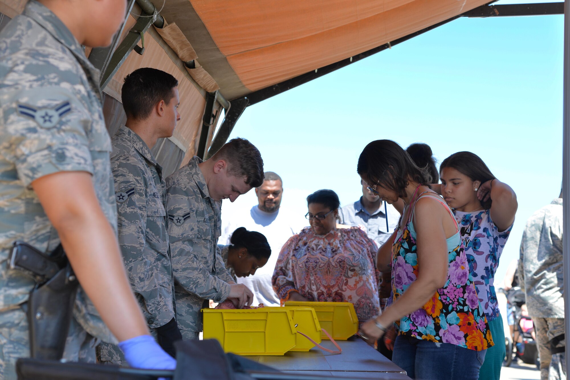 Defenders from the 2nd Security Forces Squadron inspect bags and other personal items being brought into the 2017 Defenders of Liberty Airshow on Barksdale Air Force Base, La., May 7. More than 100,000 people attended the free show this year, and each was required to go through a security screening before being allowed access. (U.S. Air Force photo//Staff Sgt. Joseph Raatz)