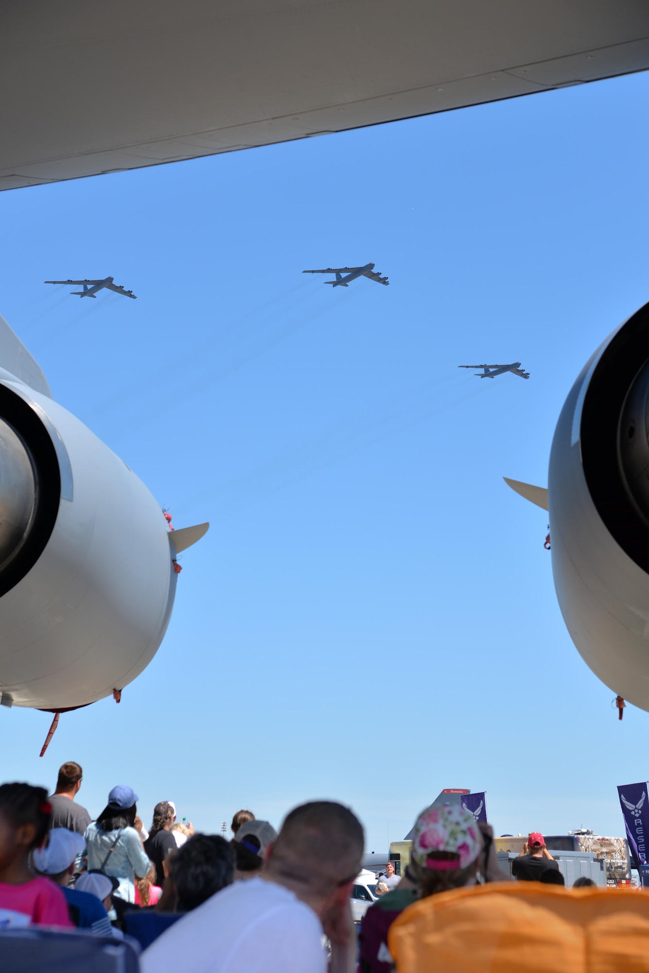 A crowd watches a three-ship formation of B-52 Stratofortresses fly overhead at the 2017 Defenders of Liberty Airshow on Barksdale Air Force Base, La., May 7. Each B-52 weighs nearly 200 tons and can carry up to 70,000 pounds of bombs, mines, or air-launched cruise missiles. (U.S. Air Force photo//Staff Sgt. Joseph Raatz)