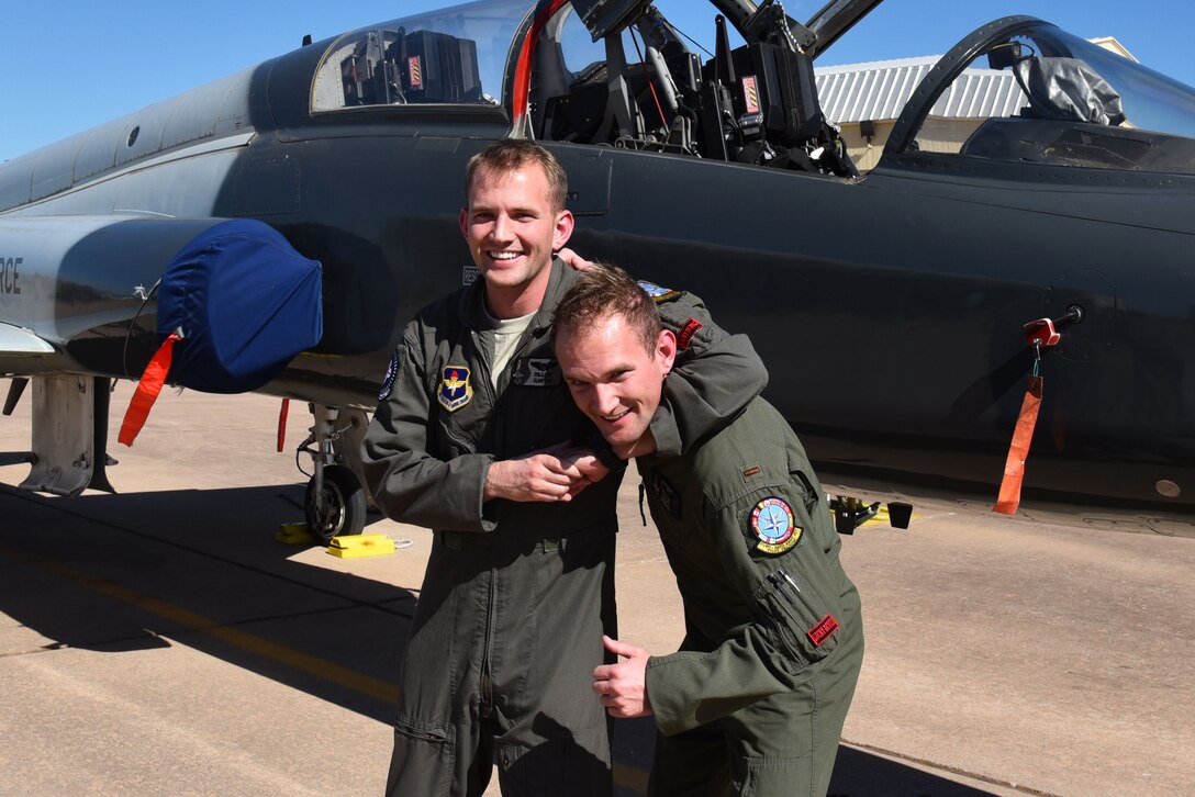 Identical twins 2nd Lt. Traverse Garvin and 2nd Lt. Dillon Garvin approach the end of their time at Sheppard Air Force Base, Texas, March 3, 2017. Their healthy sibling rivalry has helped them achieve their dream of becoming U.S. Air Force fighter pilots. (U.S. Air Force photo by 2nd Lt. Jacqueline Jastrzebski)
