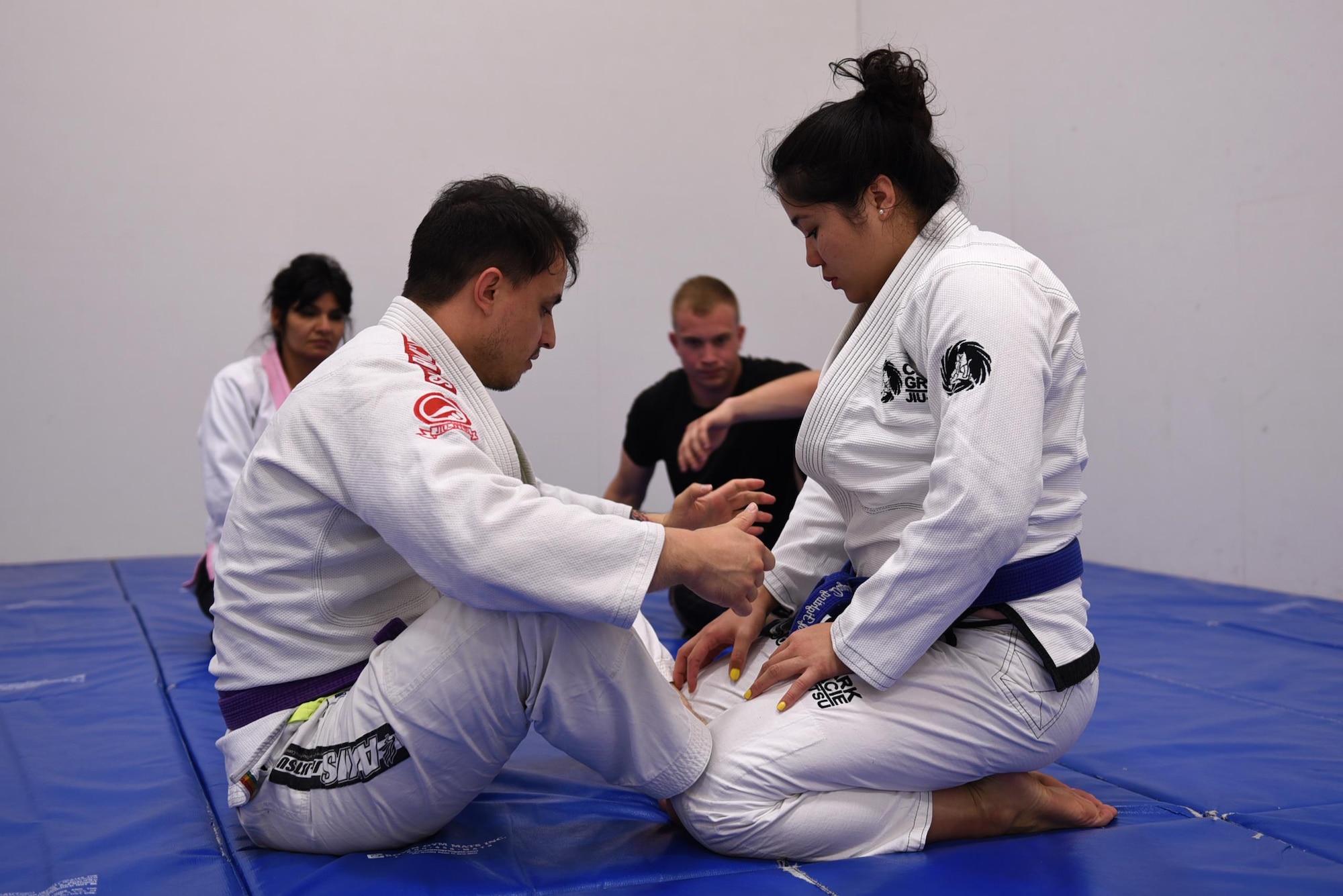 Staff Sgt. Peter Beyer, 19th Civil Engineer Squadron firefighter, and Letia Eclavea, University of Maryland University College student, instruct their students on Brazilian Jiu Jitsu grappling techniques April 24, 2017, at the Fitness Center on Little Rock Air Force Base, Ark. Beyer and Enclavea share a passion for Brazilian Jiu JItsu and host free training classes, 6—7:30 p.m., Monday—Thursday. (U.S. Air Force photo by Airman 1st Class Kevin Sommer Giron)