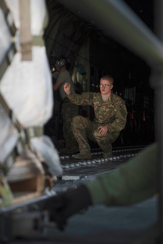 Air Force Senior Airman Brandon King uses hand signals to direct the placement of cargo on a C-130J Super Hercules aircraft at Bagram Airfield, Afghanistan, May 5, 2017. King is a loadmaster assigned to the 774th Expeditionary Airlift Squadron, which provides tactical airlift capabilities that often involves non-standard or oversized cargo and personnel movement. Air Force photo by Staff Sgt. Benjamin Gonsier