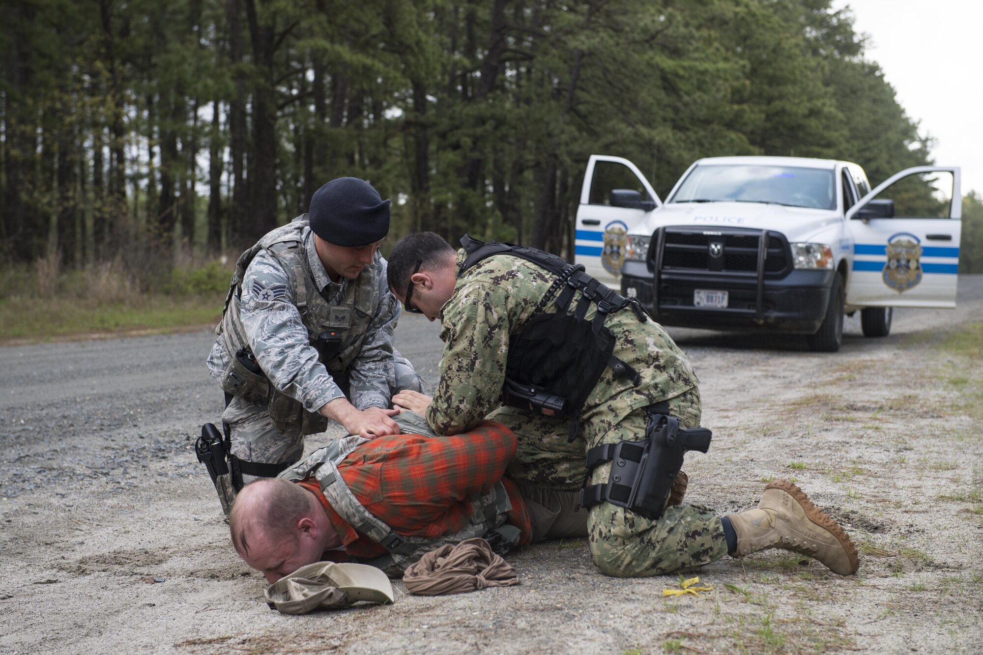 Members of the 87th Security Forces squadron apprehend a suspect during an active shooter exercise at Joint Base McGuire-Dix-Lakehurst, N.J. May 2. This exercise included a realistic and ambitious hostage negotiation scenario and exercised extended consequence management into Casualty Affairs and Next-of-Kin notification.  Four USAF commanders and NoK teams were dispatched to conduct simulated deceased members’ Next of Kin notifications.