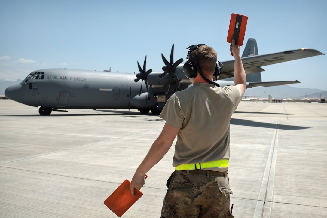 Air Force Senior Airman Phillip Vaughn marshals a C-130J Super Hercules aircraft at Bagram Airfield, Afghanistan, May 5, 2017. Vaughn is a crew chief assigned to the 455th Expeditionary Aircraft Maintenance Squadron. Air Force photo by Staff Sgt. Benjamin Gonsier