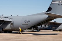 U.S. Air Force Reserve Staff Sgt. Dustin Nelson, crew chief, 913th Maintenance Squadron, pulls a set of chocks from a C-130J Super Hercules May 6, 2017, at Little Rock Air Force Base, Ark. Wheel chocks are placed in front of and behind aircraft wheels to prevent accidental movement. (U.S. Air Force photo by Master Sgt. Jeff Walston/Released)