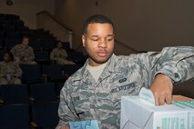 U.S. Air Force Reserve Senior Airman Gary Dyer, a squadron aviation resource management specialist assigned to the 327th Airlift Squadron, grabs hearing protection before an orientation flight on a C-130J Super Hercules May 6, 2017, at Little Rock Air Force Base, Ark. Dyer was one of 12 Airmen chosen for the flight, hosted by the 913th Airlift Group, that lets the Airmen experience the airborne operations they support from the ground. (U.S. Air Force photo by Master Sgt. Jeff Walston/Released)