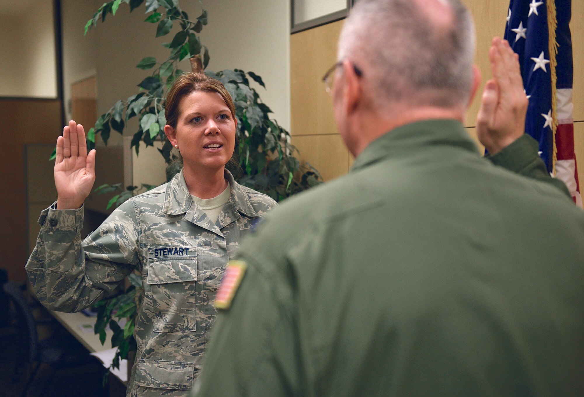 Tech. Sgt. Ginger Stewart, command post operator, 932nd Airlift Wing, recites the oath of enlistment administered by Col. Jonathan Philebaum, commander, 932nd AW, May 6, 2017, Scott Air Force Base, Illinois.  "I love being part of the 932nd mission and family and want to continue here in this great work environment," said Stewart about her motivation to re-enlist. (U.S. Air force photo by Tech. Sgt. Christopher Parr)
