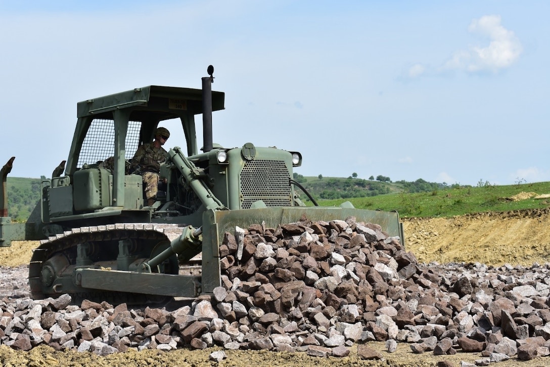 Army Reserve Spc. Jeffrey Nichols, with the 381st Engineer Company, bulldozes rock for a road on the nonstandard live-fire range at the Joint National Training Center in Cincu, Romania, as part of Resolute Castle 17, May 4, 2017. Resolute Castle 17 is an exercise strengthening the NATO alliance and enhancing its capacity for joint training and response. Army photo by Capt. Colin Cutler
