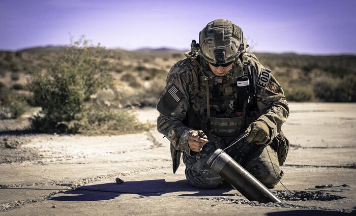 Staff Sgt. Kyle Osgood, 99th Civil Engineer Squadron explosive ordnance disposal technician, secures a line around a simulated rocket during a training exercise on Nellis Air Force Base, Nev., May 3, 2017. EOD technicians provide the ability to detect, monitor, evaluate, and decontaminate explosive, radioactive, chemical, or biological ordnance hazards. (U.S. Air Force photo by Senior Airman Kevin Tanenbaum/Released)