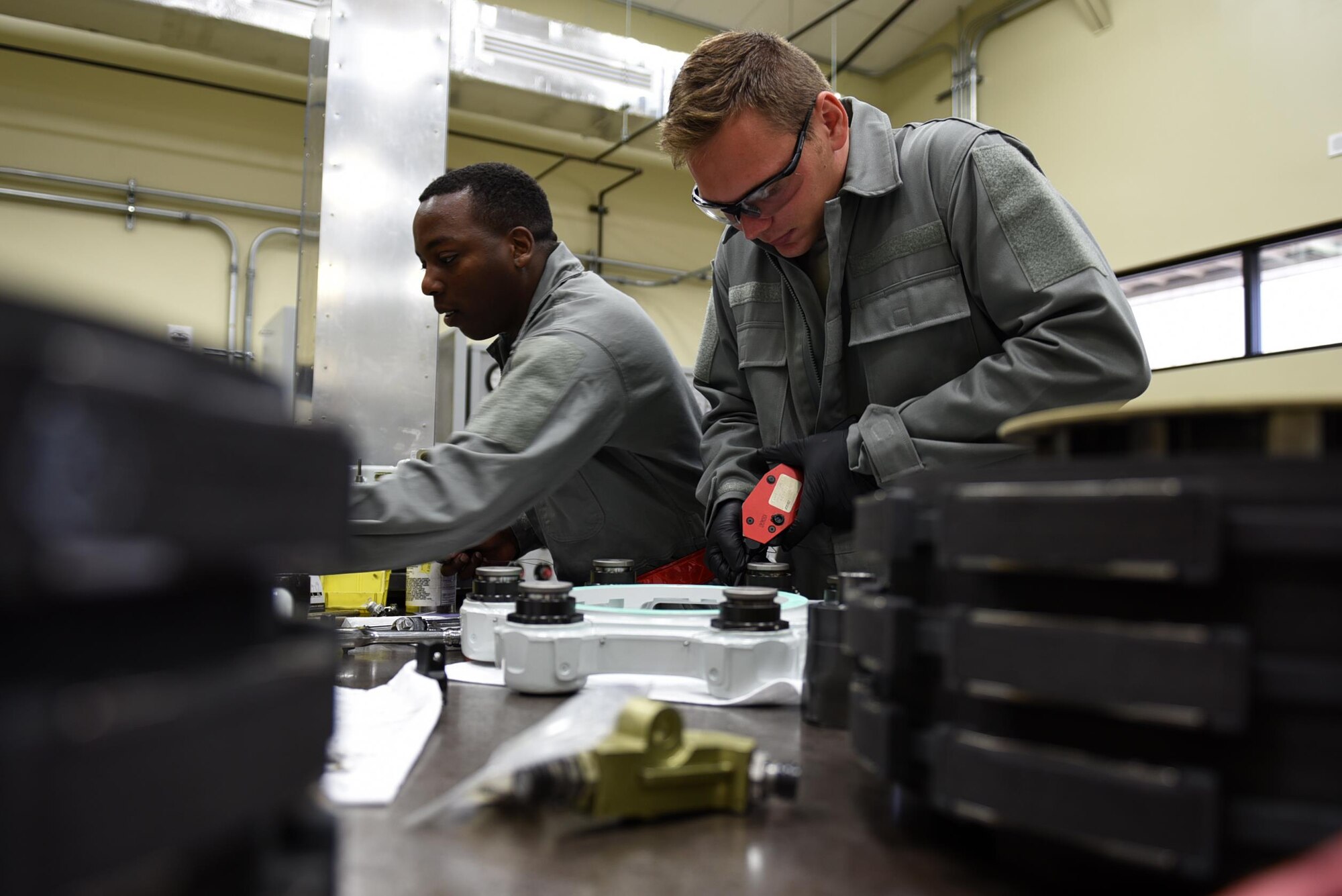 Senior Airman Kevin Heater, 19th Aircraft Maintenance Squadron Hydraulics Centralized Repair Facility journeyman, applies a safety cable to a brake shuttle valve May 2, 2017, at Little Rock Air Force Base, Ark. The safety cable prevents the brake from loosening during aircraft operations and prevents hydraulic leaks. (U.S. Air Force photo by Airman 1st Class Kevin Sommer Giron)