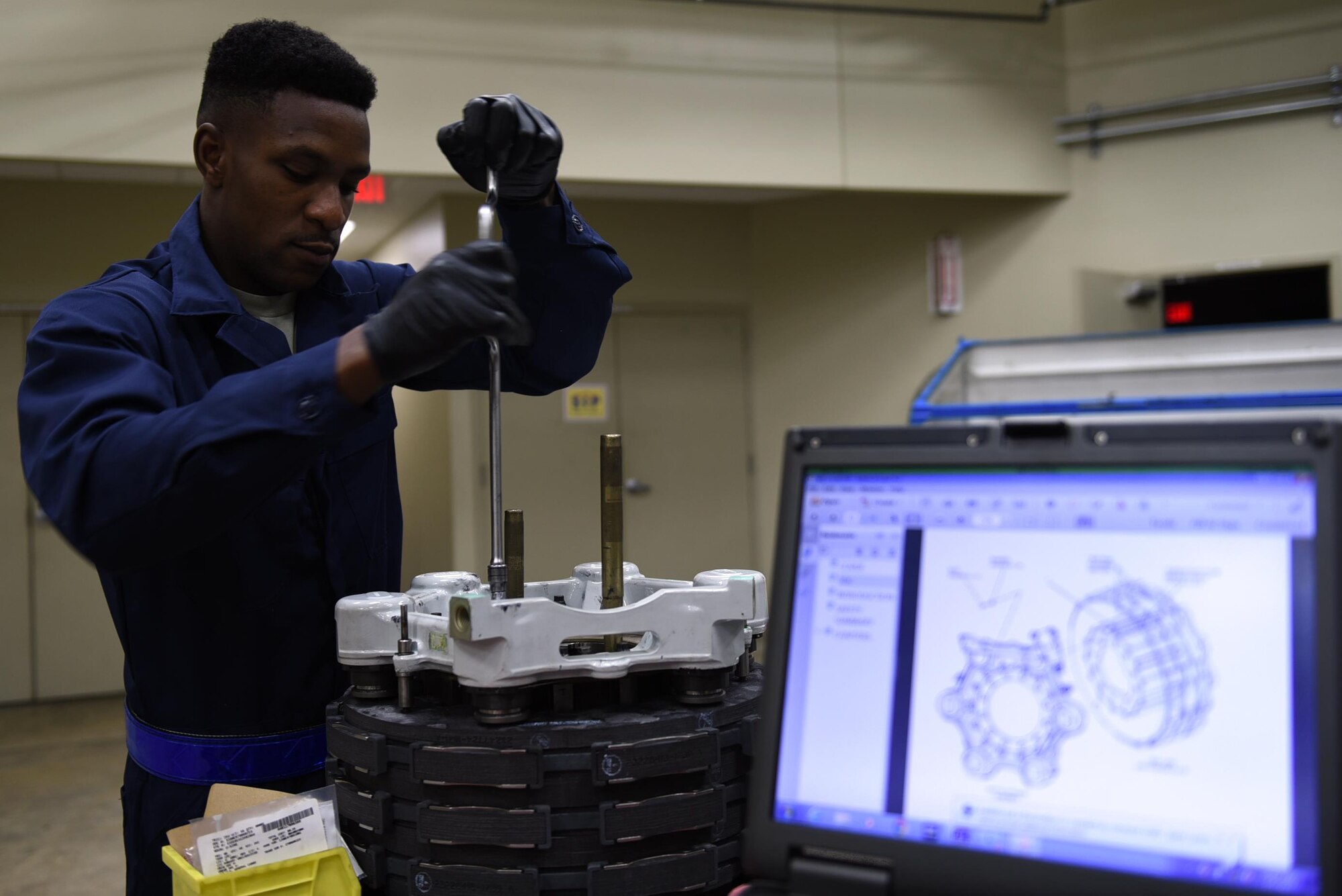 Senior Airman Osaro Obayuwana, 19th Aircraft Maintenance Squadron Hydraulics Centralized Repair Facility journeyman, assembles a C-130J carbon brake May 2, 2017, at Little Rock Air Force Base, Ark. The 19th AMXS CRF Airmen are responsible for repairing all fluid, air and gas-pressured devices on the C-130J fleet. (U.S. Air Force photo by Airman 1st Class Kevin Sommer Giron)