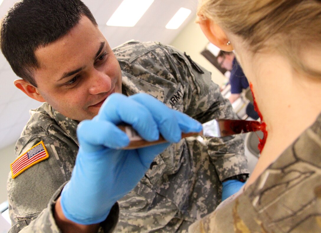 MUSCATATUCK URBAN TRAINING CENTER, Indiana – Sgt. Emmanuel Cabrera from Quebradillas, Puerto Rico, a logistic specialist with the U.S. Army Reserve’s 266th Ordnance Company, Aguadilla, Puerto Rico, creates an artificial laceration wound onto a civilian volunteer at the Muscatatuck Urban Training Center, Indiana, May 6, 2017. Nearly 4,100 Soldiers from across the country are participating in Guardian Response 17, a multi-component training exercise to validate U.S. Army units’ ability to support the Defense Support of Civil Authorities (DSCA) in the event of a Chemical, Biological, Radiological, and Nuclear (CBRN) catastrophe.