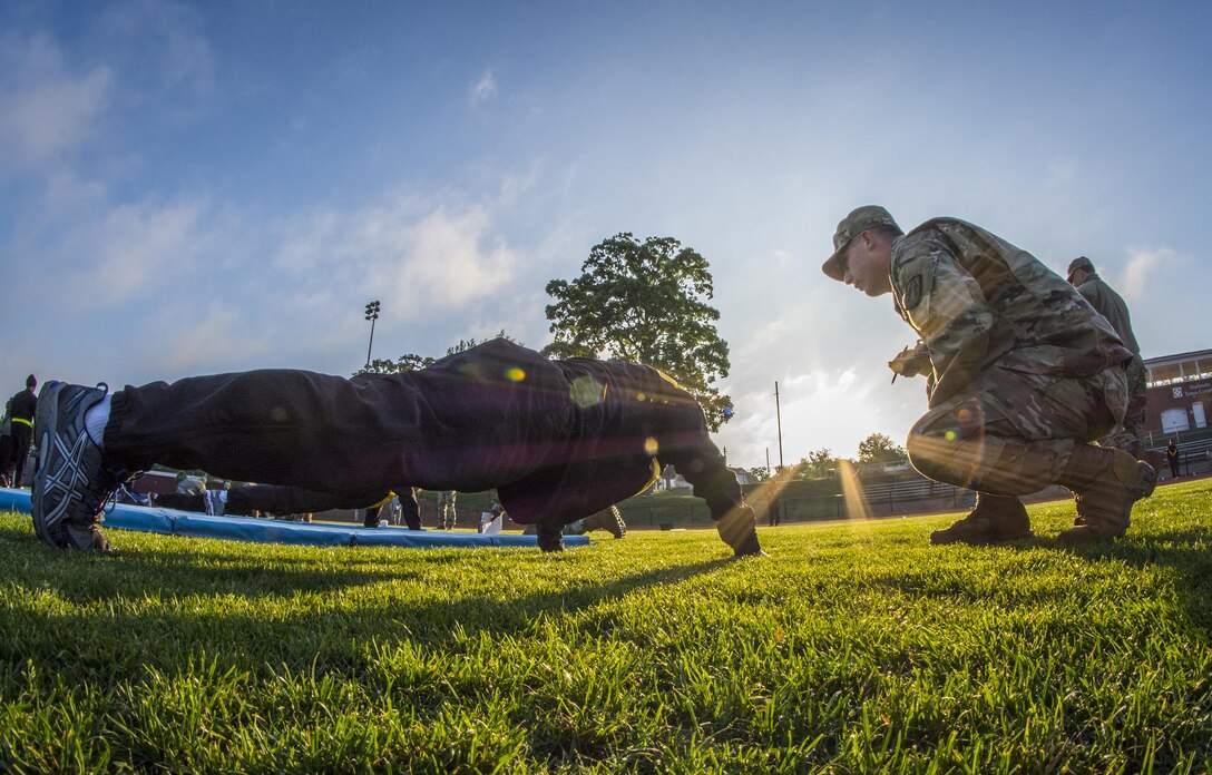 U.S. Army Reserve Sgt. 1st Class Timothy Onderko, of Lawton, Okla., grades Sgt. 1st Class Brent Powell, of Pocahontas, Ark., as Powell does push-ups to pass the Army Physical Fitness Test on a field at Woodward Academy in East Point, Ga., May 6, 2017. The APFT is designed to test the muscular strength, endurance, and cardiovascular respiratory fitness of soldiers in the Army. Soldiers are scored based on their performance in three events consisting of the push-up, sit-up, and a two-mile run, ranging from 0 to 100 points in each event. (U.S. Army Reserve photo by Staff Sgt. Ken Scar)