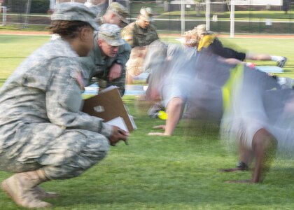 Soldiers with the U.S. Army Reserve 335th Signal Command (Theater) count and grade their fellow Soldiers as they do push-ups during an Army Physical Fitness Test in East Point, Ga., May 6, 2017. The APFT is designed to test the muscular strength, endurance, and cardiovascular respiratory fitness of soldiers in the Army. Soldiers are scored based on their performance in three events consisting of the push-up, sit-up, and a two-mile run, ranging from 0 to 100 points in each event.  (U.S. Army Reserve photo by Staff Sgt. Ken Scar)