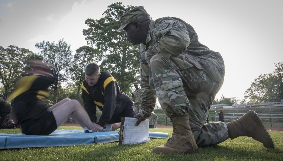 Montgomery Alabama’s own U.S. Army Reserve Staff Sgt. Eddie Lawrence, command ATARS operator for the 335th Signal Command (Theater), grades Master Sgt. Anthony Florence, 335th broadcast noncommissioned officer, during the sit-up event of the Army Physical Fitness Test in East Point, Ga., May 6, 2017. The APFT is designed to test the muscular strength, endurance, and cardiovascular respiratory fitness of soldiers in the Army. Soldiers are scored based on their performance in three events consisting of the push-up, sit-up, and a two-mile run, ranging from 0 to 100 points in each event. (U.S. Army Reserve photo by Staff Sgt. Ken Scar)