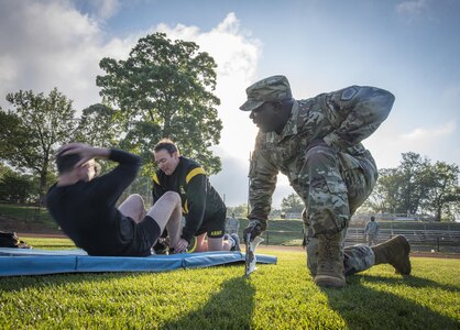 U.S. Army Reserve Staff Sgt. Eddie Lawrence, of Montgomery, Ala., the command ATARS operator for the 335th Signal Command (Theater), grades Master Sgt. Anthony Florence’s sit-ups during an Army Physical Fitness Test in East Point, Ga., May 6, 2017. The APFT is designed to test the muscular strength, endurance, and cardiovascular respiratory fitness of soldiers in the Army. Soldiers are scored based on their performance in three events consisting of the push-up, sit-up, and a two-mile run, ranging from 0 to 100 points in each event. (U.S. Army Reserve photo by Staff Sgt. Ken Scar)