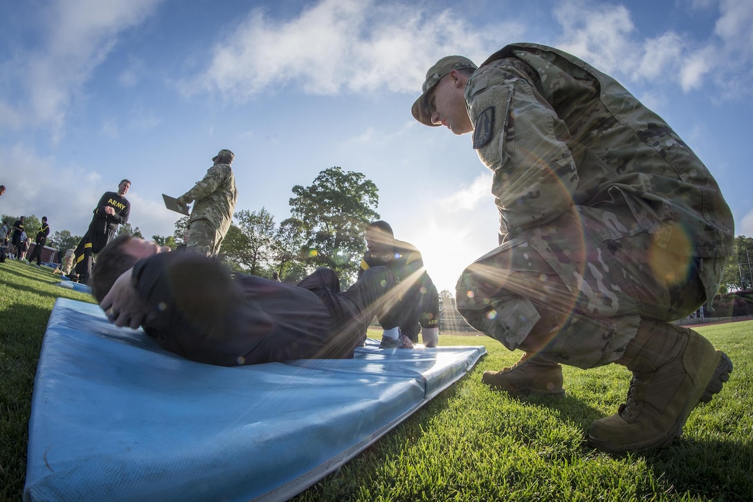 U.S. Army Reserve Sgt. 1st Class Timothy Onderko, of Lawton, Ok., grades Sgt. 1st Class Brent Powell, of Pocahontas, Ark., as Powell does push-ups to pass the Army Physical Fitness Test on a field at Woodward Academy in East Point, Ga., May 6, 2017. The APFT is designed to test the muscular strength, endurance, and cardiovascular respiratory fitness of soldiers in the Army. Soldiers are scored based on their performance in three events consisting of the push-up, sit-up, and a two-mile run, ranging from 0 to 100 points in each event. (U.S. Army Reserve photo by Staff Sgt. Ken Scar)