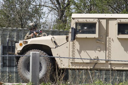 A U.S. Army Reserve Soldier from the 401st Engineer Company (Multi-Role Bridge Company) takes cover behind his Humvee during convoy operations training on Fort McCoy, Wis., as part of Warrior Exercise 86-17-02, May 3, 2017. More than 70 U.S. Army Reserve units conducted combat training to increase their lethality as cohesive units of action during the 84th Training Command’s WAREX 86-17-02 at Fort McCoy from April 29 until May 13, 2017. (U.S. Army Reserve photo by Sgt. Beth Raney, 343rd Mobile Public Affairs Detachment)