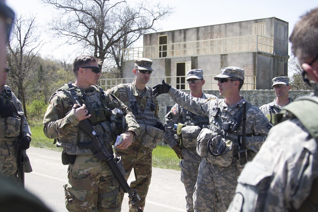 U.S. Army Sgt. 1st Class Paul Brantley (right, gesturing), an Observer-Coach-Trainer with the 181st Multi-Functional Training Brigade and native of Mobile, Ala., provides critical feedback to U.S. Army Reserve Soldiers of the  341st Engineer Company after their convoy operations training on Fort McCoy, Wis., as part of Warrior Exercise 86-17-02, May 3, 2017. More than 70 U.S. Army Reserve units are conducted combat training to increase their lethality as cohesive units of action during the 84th Training Command’s WAREX 86-17-02 at Fort McCoy, Wis. from April 29 until May 13, 2017. (U.S. Army Reserve photo by Sgt. Beth Raney, 343rd Mobile Public Affairs Detachment)