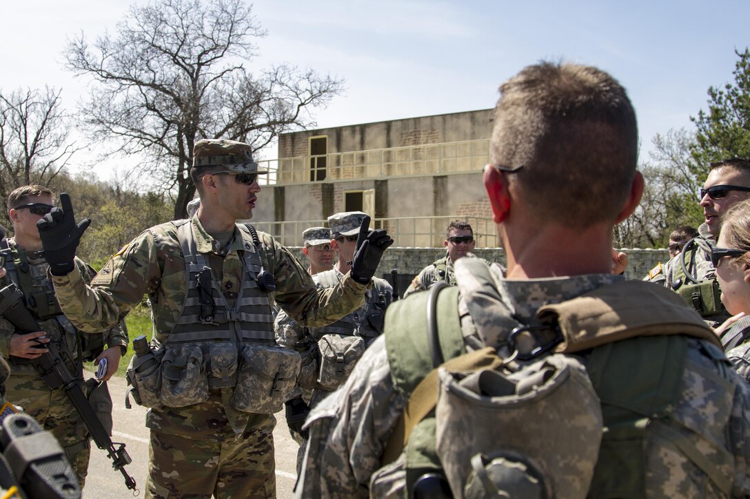 U.S. Army Staff Sgt. Kevin Graham, a combat engineer and Observer-Coach-Trainer with the Active Component/Reserve Component of the 181st Multi-Functional Training Brigade reviews the procedures of responding to enemy contact with U.S. Army Reserve Soldiers from the 341st Engineer Company and 401st Engineer Company (Multi-Role Bridge Company) as they gather on completion of a training lane on Fort McCoy, Wis., as part of Warrior Exercise 86-17-02, May 3, 2017. More than 70 U.S. Army Reserve units conducted combat training to increase their lethality as cohesive units of action during the 84th Training Command’s WAREX 86-17-02 at Fort McCoy, Wis., April 29 through May 13, 2017. (U.S. Army Reserve photo by Sgt. Beth Raney, 343rd Mobile Public Affairs Detachment)