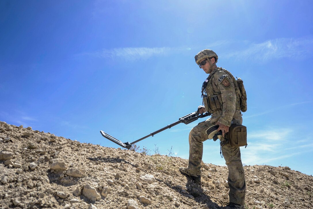 Air Force Staff Sgt. Kyle Osgood uses a metal detector to clear a perimeter of explosives during a training exercise at Nellis Air Force Base, Nev., May 3, 2017. Air Force photo by Senior Airman Kevin Tanenbaum