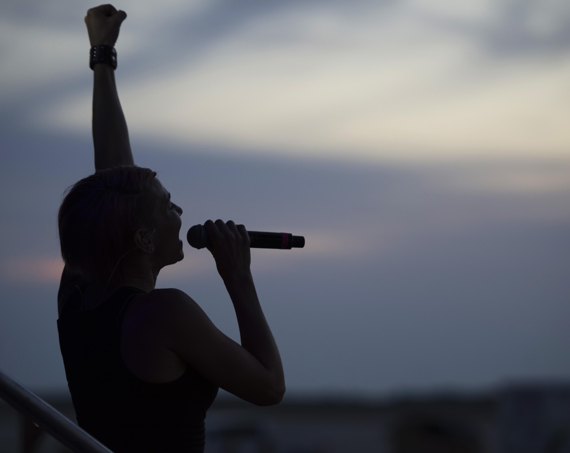 Molly Callinan, a vocalist with the Lt. Dan Band, pumps up the crowd during a performance at MacDill Air Force Base, Fla., April 29, 2017. The band, founded by actor Gary Sinise, tours various military installations to give back to the military community. (U.S. Air Force photo by Airman 1st Class Adam R. Shanks)