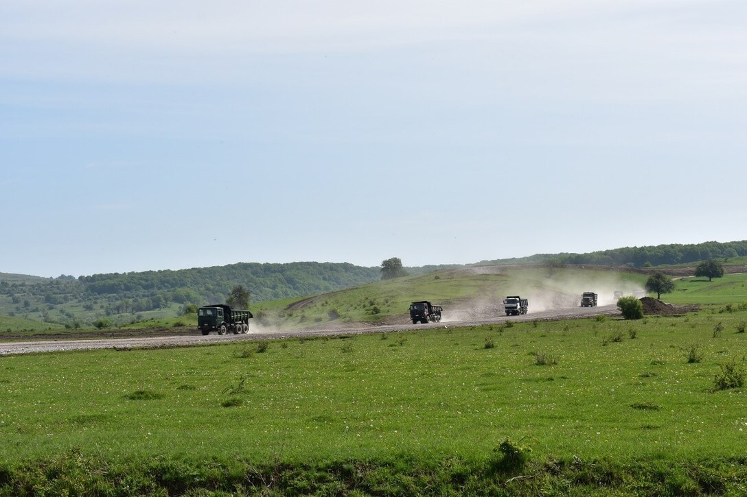 Trucks from 381st Engineer Company, 926th Engineer Battalion, 926th Engineer Brigade, United States Army Reserves, and the Romanian 10th Engineer Brigade return from dropping rock at the Non-Standard Live-Fire Range at Joint National Training Center, Cincu, Romania, working in conjunction as part of Resolute Castle 17.  Resolute Castle 17 is an exercise strengthening the NATO alliance and enhancing its capacity for joint training and response to threats within the region.