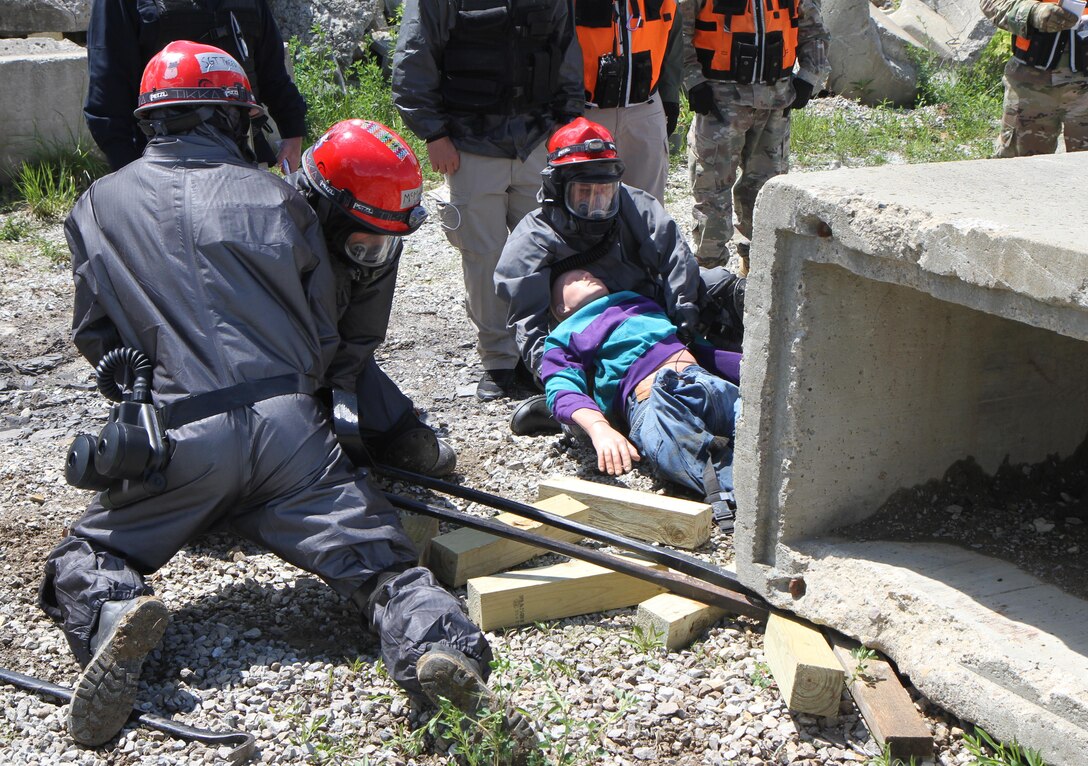 Army Reserve units hit the ground running at Muscatatuck Urban Training Center, Indiana, as the second phase of Guardian Response 17 kicked off. Soldiers from the 468th Fire Fighting Detachment suited up and surveyed the area before searching and extracting casualties of a simulated nuclear attack on May 06, 2017. 

Nearly 5,000 Soldiers and Airmen from across the country are participating in Guardian Response 17, a multi-component training exercise to validate the military's ability to support Civil Authorities in the event of a Chemical, Biological, Radiological, and Nuclear (CBRN) catastrophe. (U.S. Army Reserve photo by Staff Sgt. Christopher Sofia/Released)