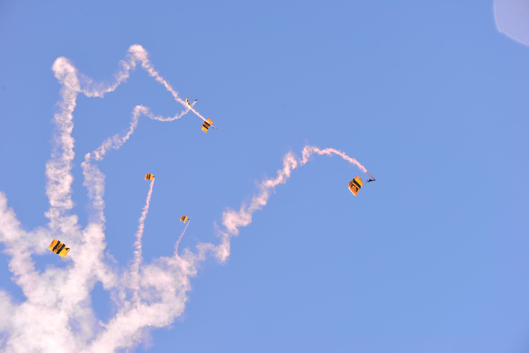 The U.S. Army Golden Knights parachute team perform skydiving maneuvers May 4 at Fairfield High School in Fairfield, Calif. The Golden Knights are in Northern California for the "Wings Over Solano" Air Show May 6-7 at Travis Air Force Base. (U.S. Air Force photo/Senior Airman Amber Carter)