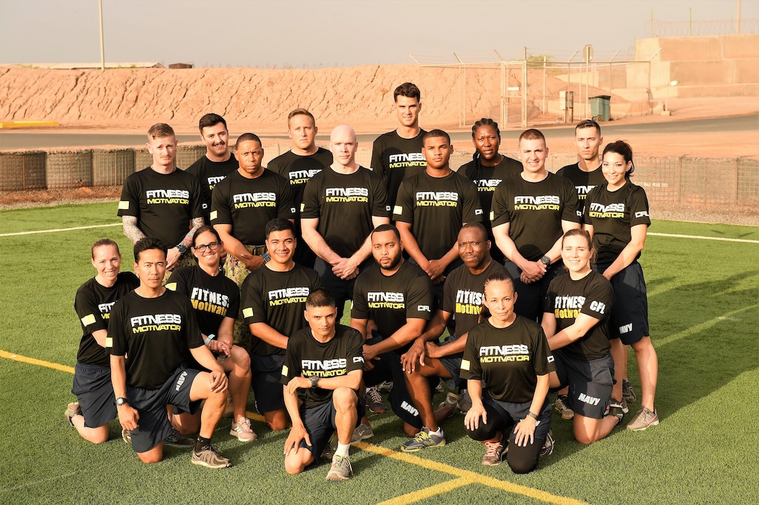 Members of Camp Lemmonier and Combined Joint Task Force Horn of Africa fitness leaders show off their new assistant command fitness leader physical training shirts at Camp Lemonnier, Djibouti, April 28, 2017. Navy fitness leaders commonly wear distinctive shirts to signify their role in assisting with their shipmates’ fitness success. Air Force photo by Tech. Sgt. Andria Allmond