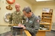 Retired colonel and former Vietnam prisoner of war Lee Ellis autographs his book for Maj. Joseph Lopez, 351st Battlefield Airman Training Squadron commander. Ellis was at Kirtland May 2-3 to speak to the base about the importance of character, courage, commitment in leaders.