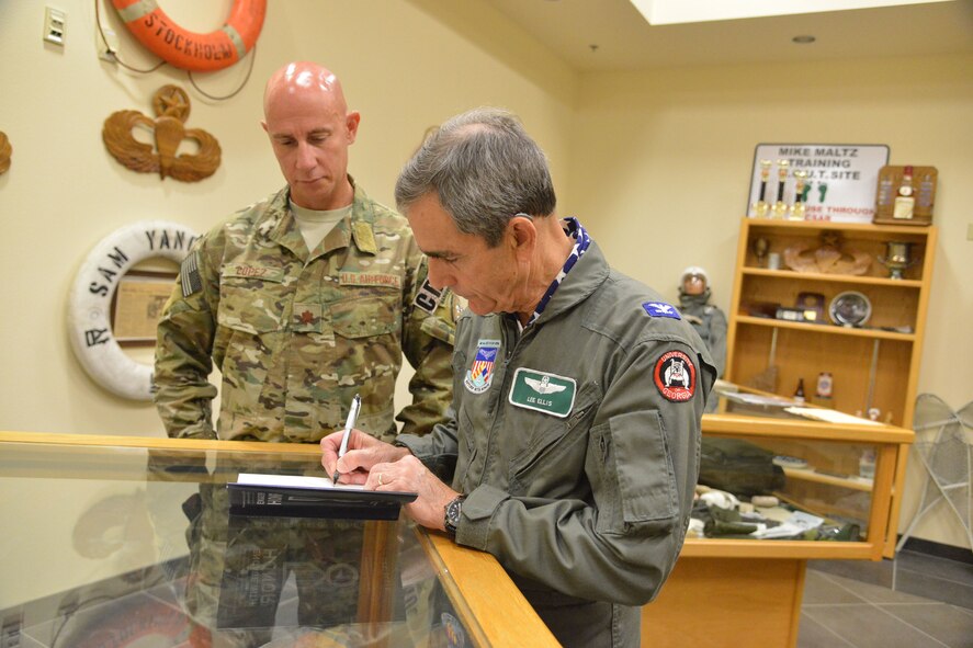 Retired colonel and former Vietnam prisoner of war Lee Ellis autographs his book for Maj. Joseph Lopez, 351st Battlefield Airman Training Squadron commander. Ellis was at Kirtland May 2-3 to speak to the base about the importance of character, courage, commitment in leaders.