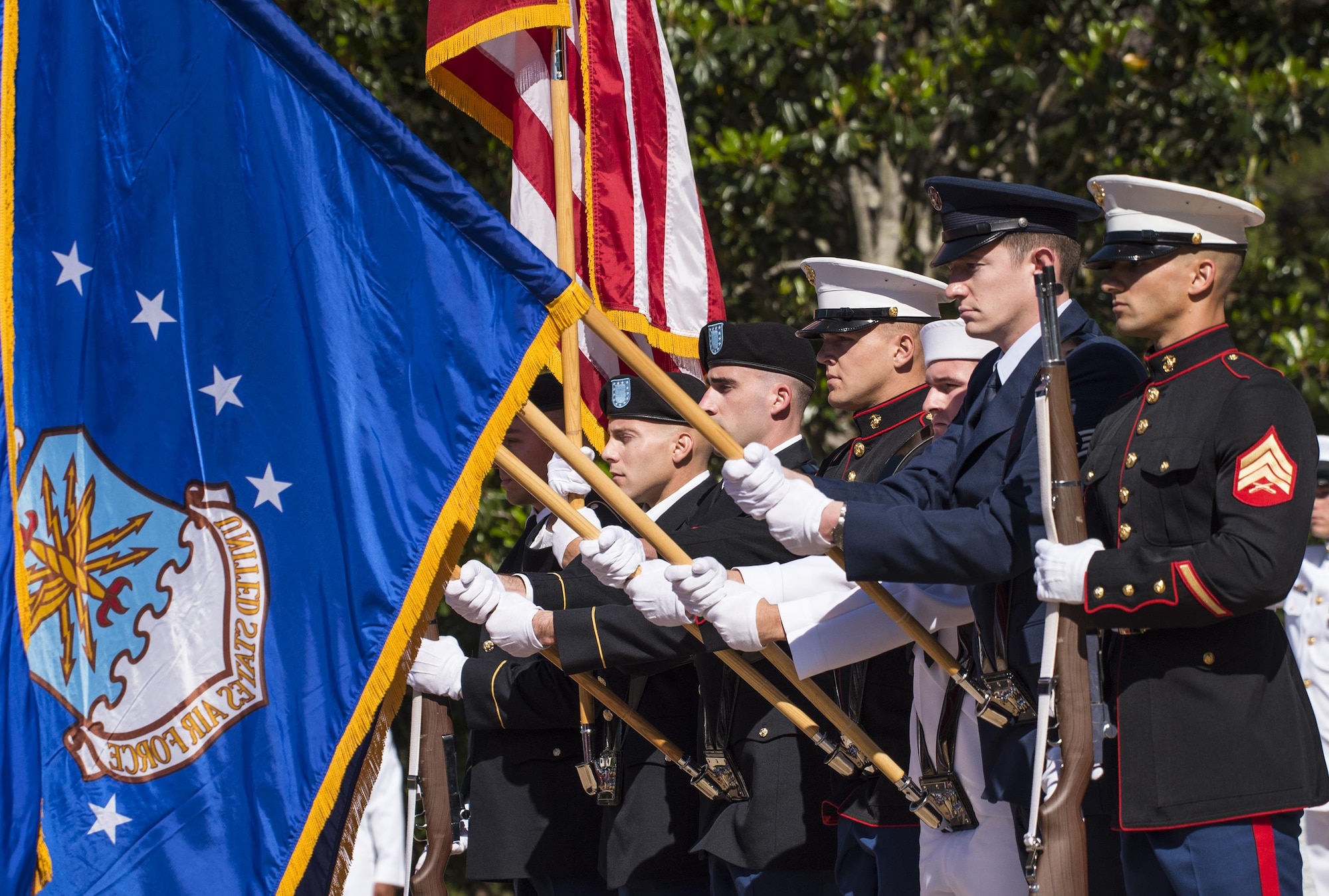 A joint-service color guard brings in the flags at the beginning of the 48th Annual Explosive Ordnance Disposal Memorial ceremony at the Kauffman EOD Training Complex at Eglin Air Force Base, Fla., May 6. Names of recent fallen and past EOD technicians are added to the memorial wall during a ceremony each year. The Army and Navy added six new names this year. The all-service total now stands at 326. (U.S. Air Force photo/ Samuel King Jr.)