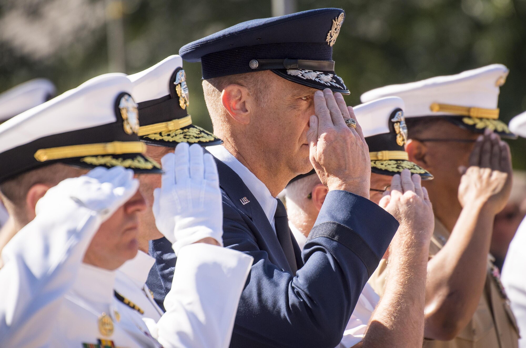 Lt. Gen. John B. Cooper, Air Force Deputy Chief of Staff for Logistics, Engineering and Force Protection, salutes with Navy leadership at the 48th Annual Explosive Ordnance Disposal Memorial ceremony May 6. Names of recent fallen and past EOD technicians are added to the memorial wall during a ceremony each year at the Kauffman EOD Training Complex at Eglin Air Force Base, Fla.  The Army and Navy added six new names this year. The all-service total now stands at 326. (U.S. Air Force photo/ Samuel King Jr.)