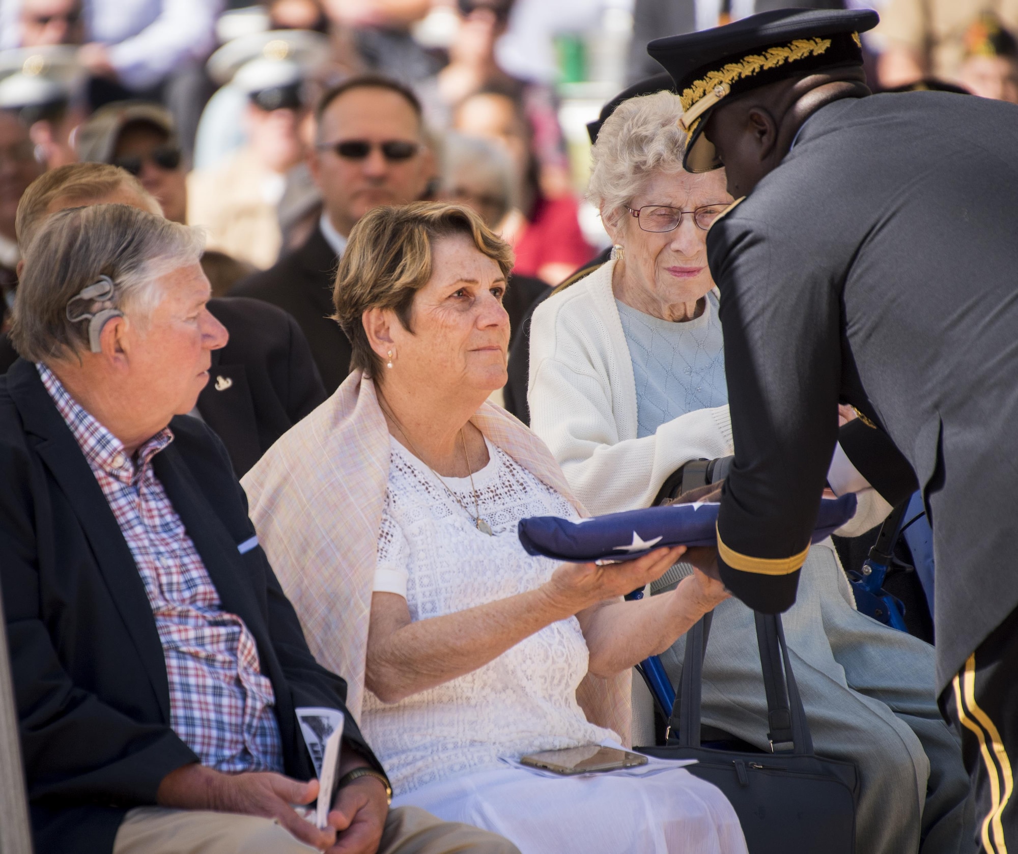 Brig. Gen. David Wilson, U.S. Army Ordnance School commandant, presents a folded flag to Margaret Lauterjung, sister of Army Tech. Sgt. James Eberle, during the 48th Annual Explosive Ordnance Disposal Memorial Service, May 6. Eberle and other names of recent fallen and past EOD technicians are added to the memorial wall during a ceremony each year at the Kauffman EOD Training Complex at Eglin Air Force Base, Fla. The Army and Navy added six new names this year. The all-service total now stands at 326. (U.S. Air Force photo/ Samuel King Jr.)