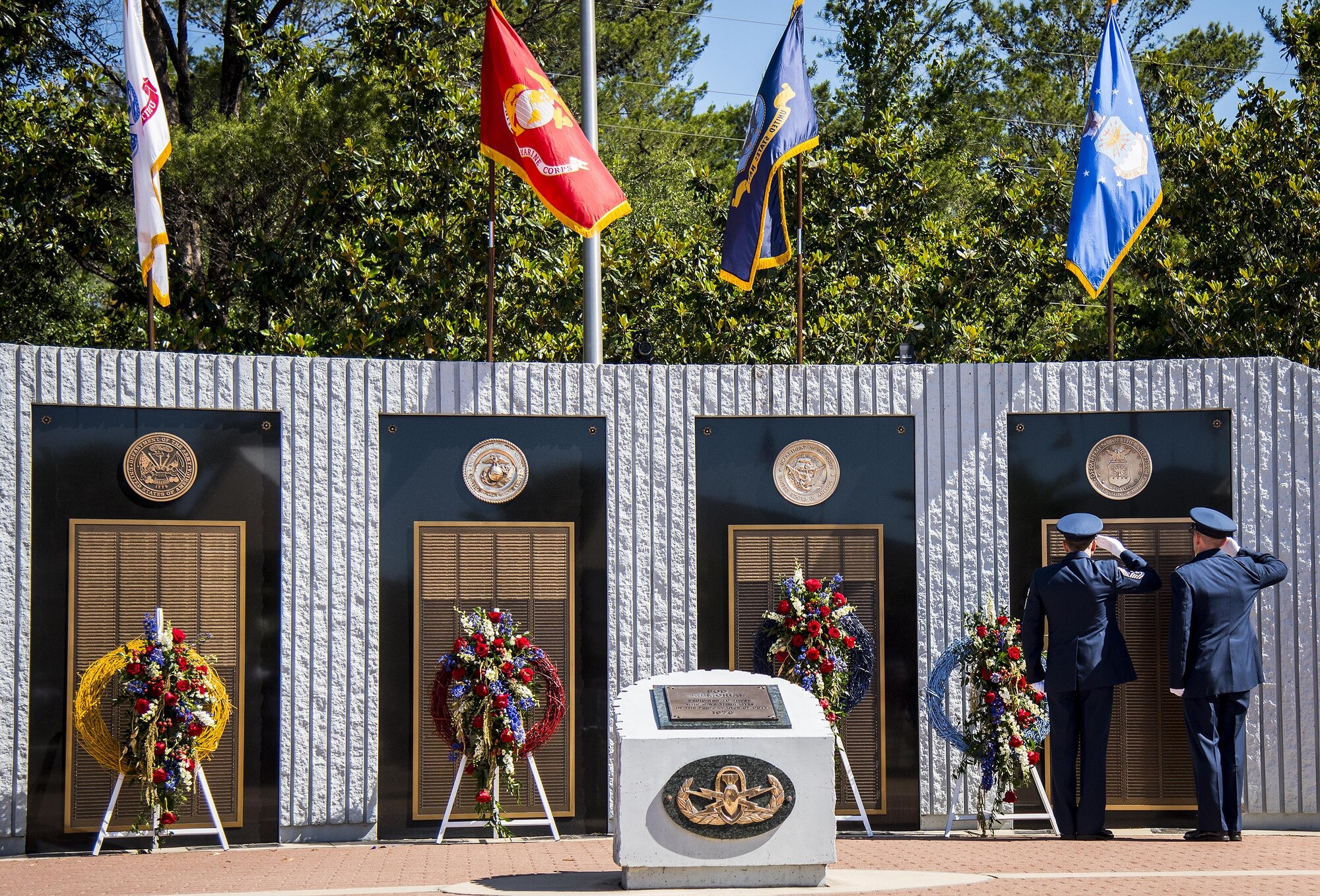 Chief Master Sgt. Martin Cortez and Lt. Col. Emil Rebik salute the list of lost Air Force explosive ordnance disposal technicians during the 48th Annual EOD Memorial Service, May 6. Names of recent fallen and past EOD technicians are added to the memorial wall and flags presented to their families during a ceremony each year at the Kauffman EOD Training Complex at Eglin Air Force Base, Fla. The Army and Navy added six new names this year. The all-service total now stands at 326. (U.S. Air Force photo/ Samuel King Jr.)