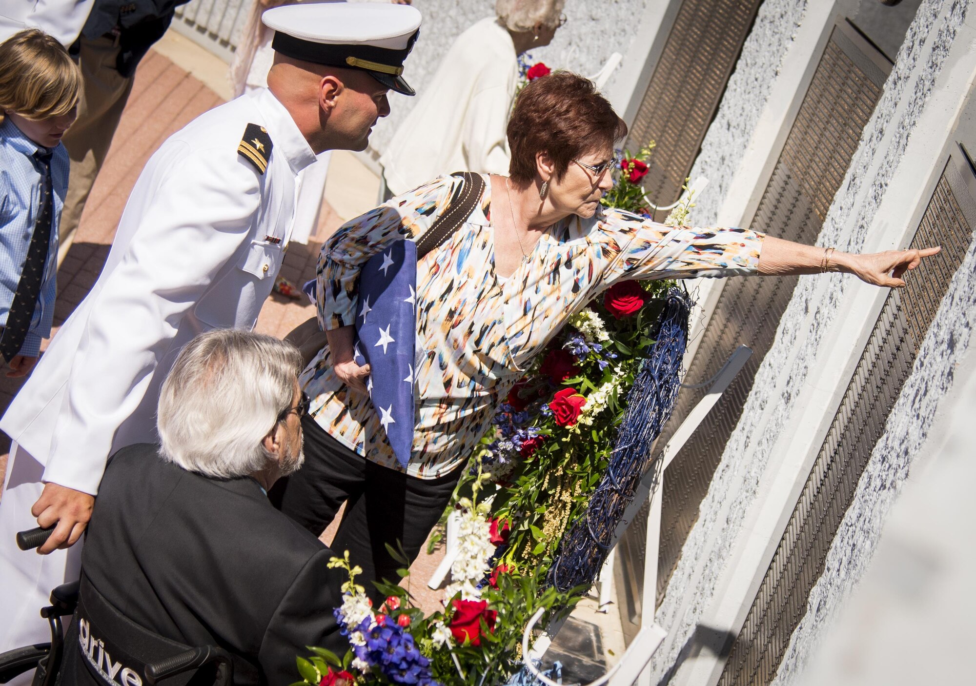 The family of Ensign Charles Grice see his name enshrined on the wall for the first time during the 48th Annual Explosive Ordnance Disposal Memorial Service, May 6. Grice and names of recent fallen and past EOD technicians are added to the memorial wall and flags presented to their families during a ceremony each year at the Kauffman EOD Training Complex at Eglin Air Force Base, Fla. The Army and Navy added six new names this year. The all-service total now stands at 326. (U.S. Air Force photo/ Samuel King Jr.)