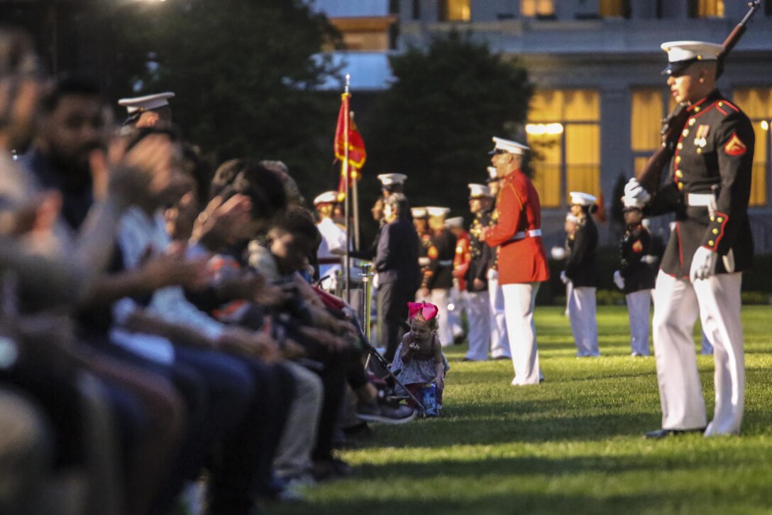 Crowd educators with Marine Barracks Washington D.C. give guests a brief history of the Barracks during a Friday Evening Parade at Marine Barracks Washington D.C., May 5, 2017. The guests of honor for the parade were the Honorable Paul Cook, California’s 8th Congressional District Congressman, the Honorable Jack Bergman, Michigan’s 1st Congressional District Congressman, and the Honorable Salud Carbajal, California’s 24th Congressional District Congressman. The hosting official was Gen. Glenn Walters, assistant commandant of the Marine Corps.(Official Marine Corps photo by Lance Cpl. Damon Mclean/Released)