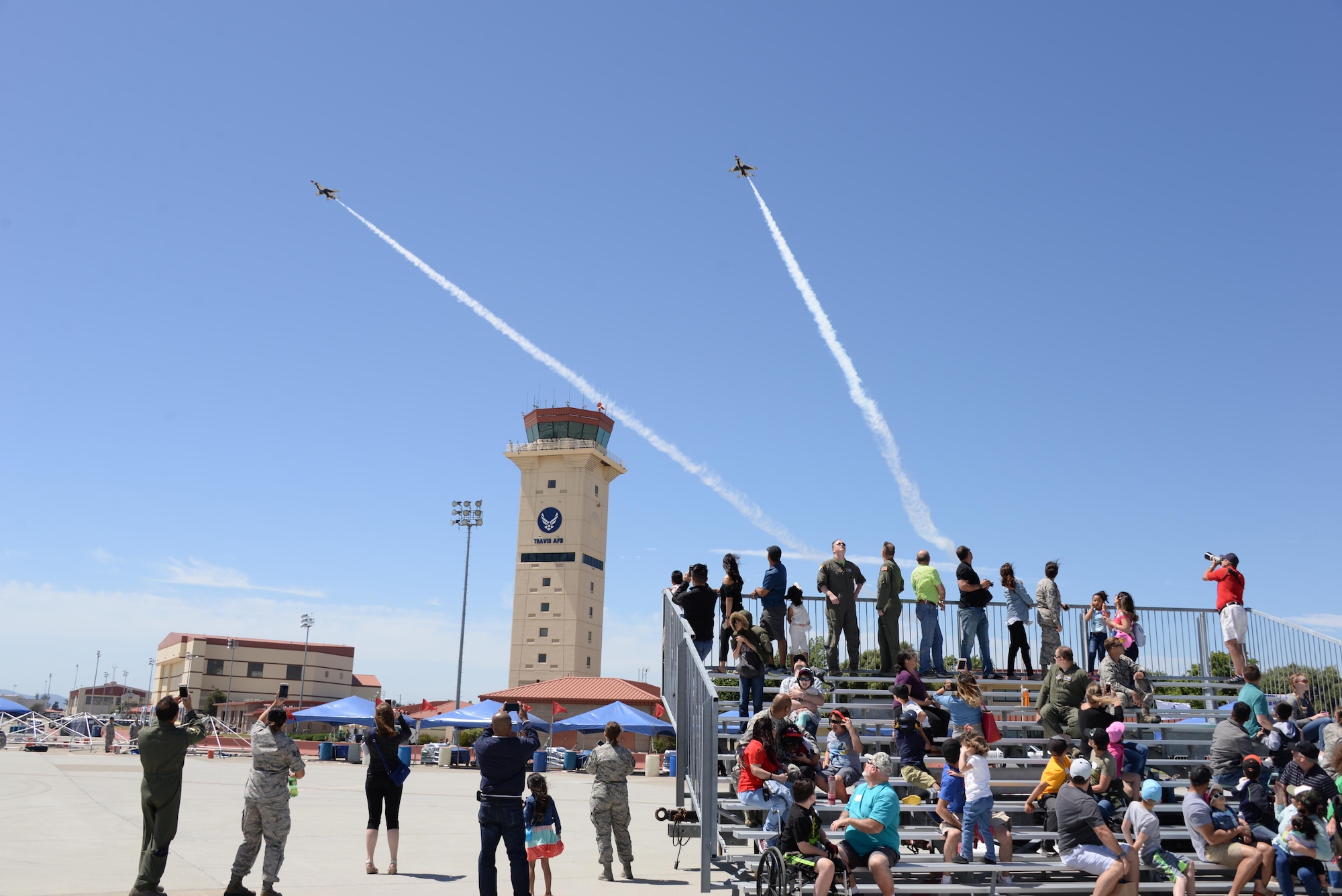 Make-A-Wish families watch from the bleachers as the U.S. Air Force Thunderbirds practice their aerial demonstrations May 5, 2017 prior to the Wings Over Solano Air Show at Travis Air Force Base, Calif. The two-day event featured performances by the Thunderbirds, flyovers and static displays. (U.S. Air Force photo by Senior Airman Amber Carter)