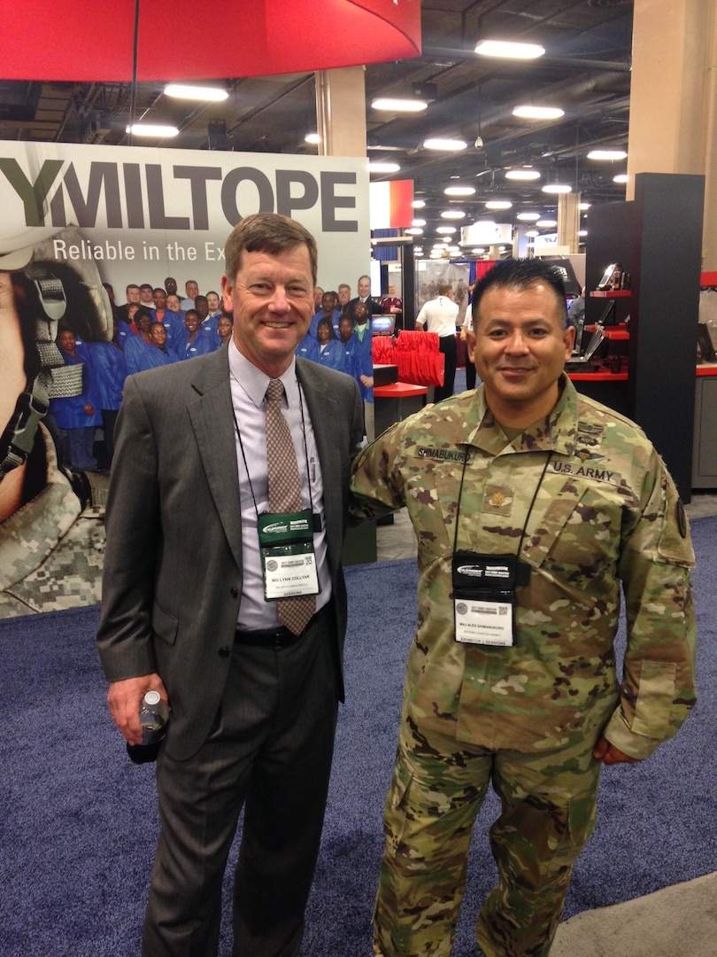 Retired U.S. Army Maj. Gen. Lynn A. Collyar visits with Army Maj. Alex Shimabukuro, Defense Logistics Agency Aviation Army Customer Facing Division operations officer April 27, 2017 at DLA's exhibit during the 2017 Army Aviation Mission Solutions Summit at the Gaylord Opryland Resort and Convention Center in Nashville, Tennessee. The DLA team attended the two-day event to answer customers' support questions. 