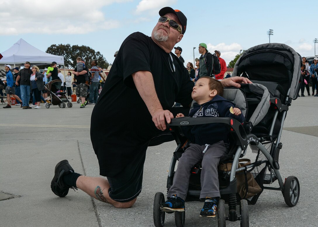 A family watches an aerial performer at Wings Over Solano, the Travis Air Show, at Travis Air Force Base, Calif., on May 6, 2017. The two-day event featured performances by the U.S. Army Golden Knights, Thunderbirds, flyovers and static displays. (U.S. Air Force photo by Staff Sgt. Daniel Phelps)