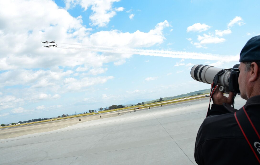 A photographer takes photos of the U.S. Air Force Thunderbirds during Wings Over Solano at Travis Air Force Base, Calif., on May 6, 2017. The two-day event featured performances by the U.S. Army Golden Knights, Thunderbirds, flyovers and static displays. (U.S. Air Force photo by Staff Sgt. Daniel Phelps)