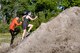 Participants climb a hill during the annual Moody Mud Run, May 6, 2017, in Ray City, Ga. The Fourth Annual Moody Mud consisted of both adult and child course that challenged more than 600 participants with obstacles over 4.2 miles. (U.S. Air Force photo by Airman 1st Class Daniel Snider)