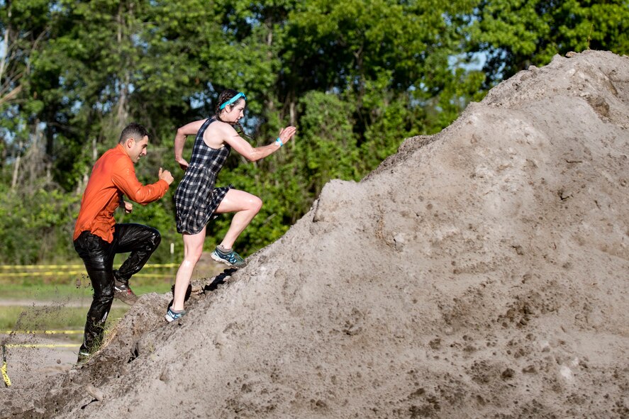 Participants climb a hill during the annual Moody Mud Run, May 6, 2017, in Ray City, Ga. The Fourth Annual Moody Mud consisted of both adult and child course that challenged more than 600 participants with obstacles over 4.2 miles. (U.S. Air Force photo by Airman 1st Class Daniel Snider)