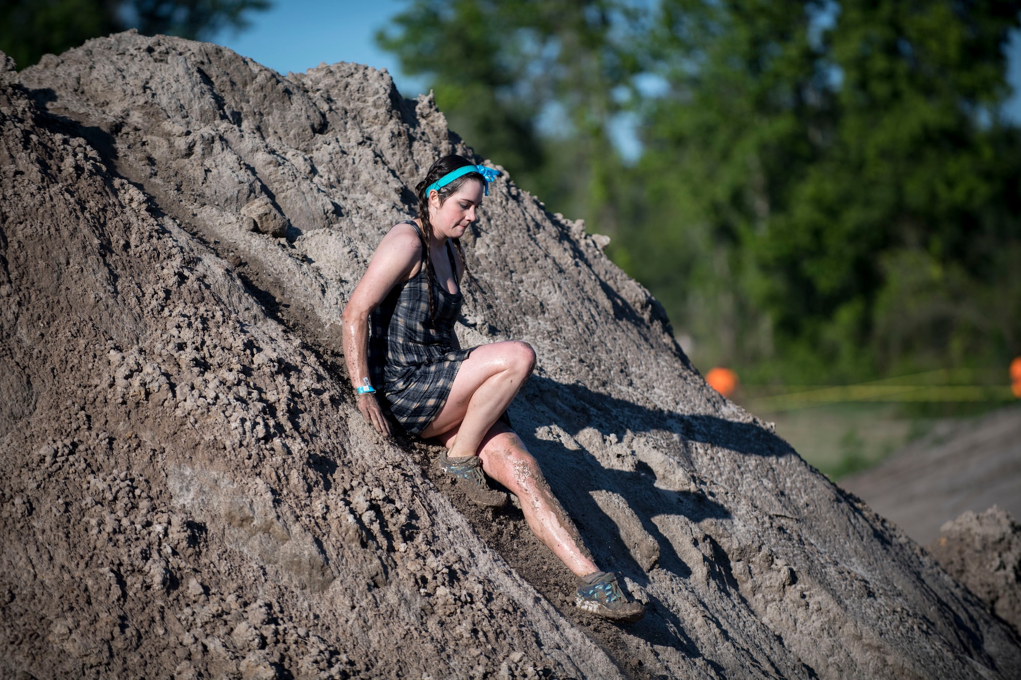 A participant slides down a dirt mound during the annual Moody Mud Run, May 6, 2017, in Ray City, Ga. The Fourth Annual Moody Mud consisted of both adult and child course that challenged more than 600 participants with obstacles over 4.2 miles. (U.S. Air Force photo by Airman 1st Class Daniel Snider)