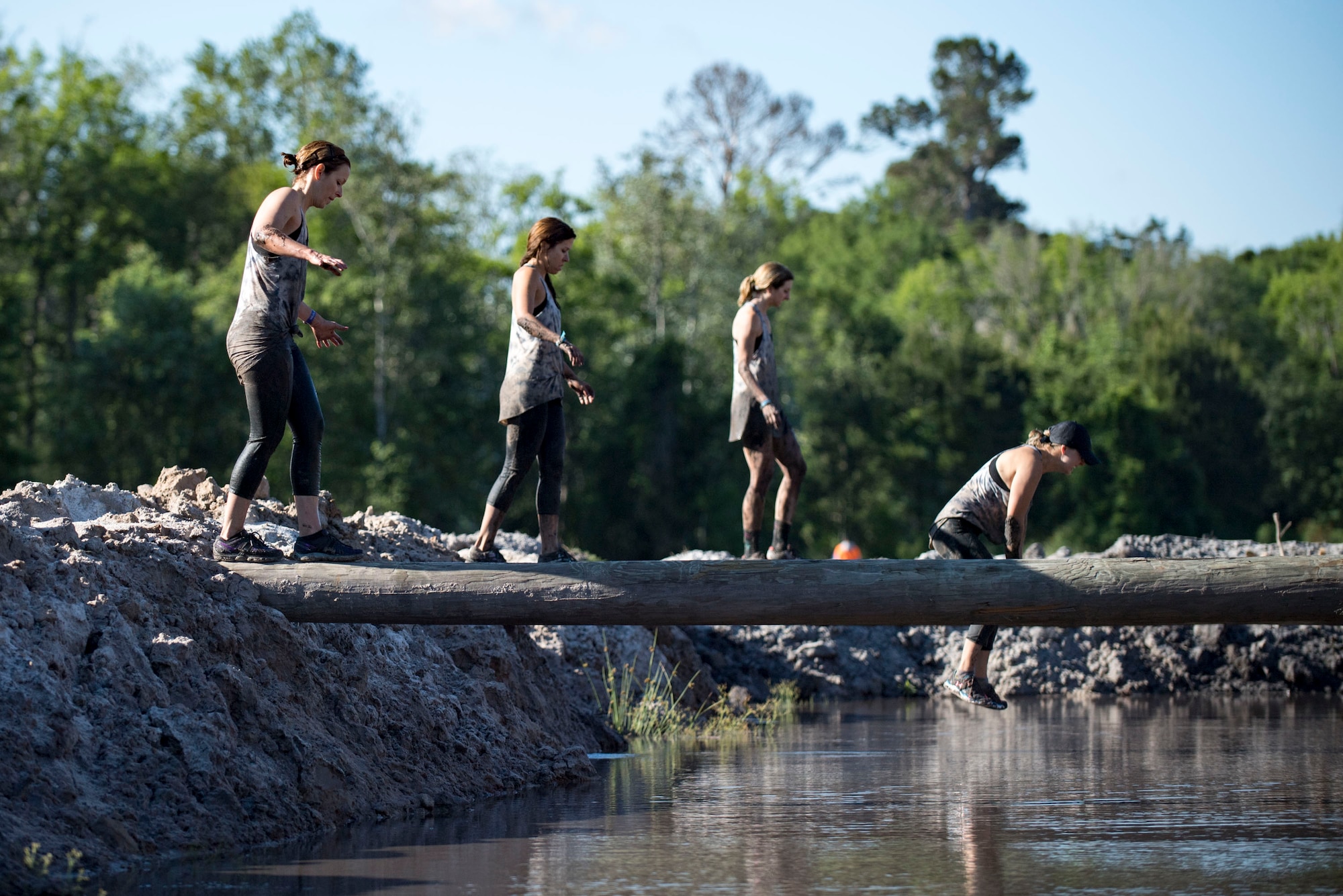 Participants attempt a log crossing during the annual Moody Mud Run, May 6, 2017, in Ray City, Ga. The Fourth Annual Moody Mud consisted of both adult and child course that challenged more than 600 participants with obstacles over 4.2 miles. (U.S. Air Force photo by Airman 1st Class Daniel Snider)