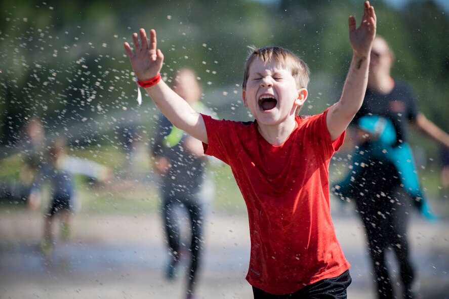A child participant rushes through water during the annual Moody Mud Run, May 6, 2017, in Ray City, Ga. The Fourth Annual Moody Mud consisted of both adult and child course that challenged more than 600 participants with obstacles over 4.2 miles. (U.S. Air Force photo by Airman 1st Class Daniel Snider)