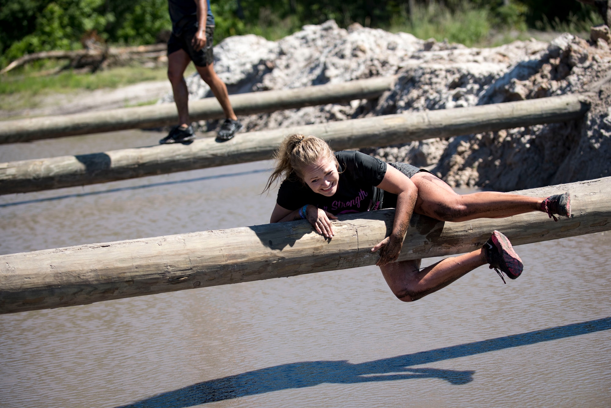 A participant clings to a log during the Moody annual Mud Run, May 6, 2017, in Ray City, Ga. The Fourth Annual Moody Mud consisted of both adult and child course that challenged more than 600 participants with obstacles over 4.2 miles. (U.S. Air Force photo by Airman 1st Class Daniel Snider)